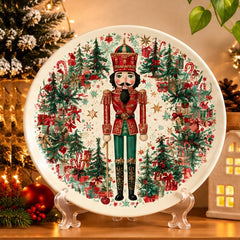 Nutcracker Evergreen Christmas Gift Wall Plate on a tabletop stand