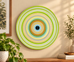 Lime Halo Concentric Abstract Ceramic Decorative Wall Plate displayed on a wall