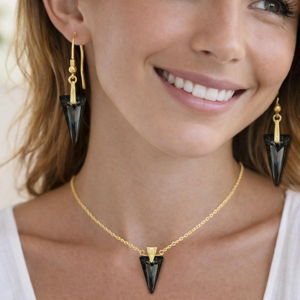 gold necklace and black earrings