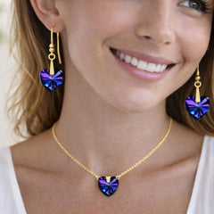 gold necklace and heart-shaped purple earrings