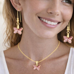 silver necklace and pink butterfly earrings.