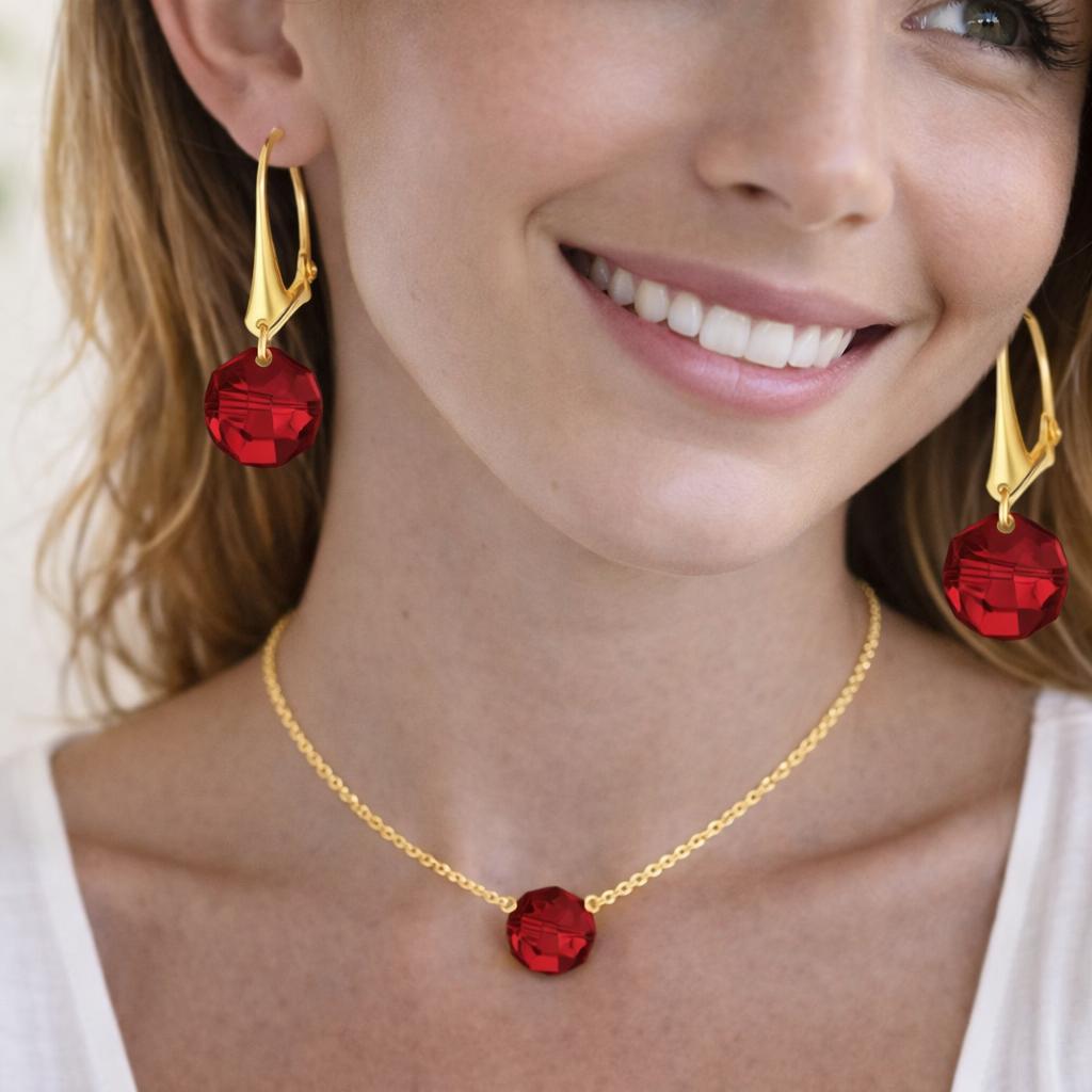 gold necklace and red earrings