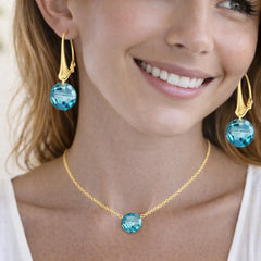 gold necklace and earrings with blue gemstones