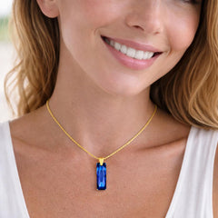 gold necklace with a blue pendant