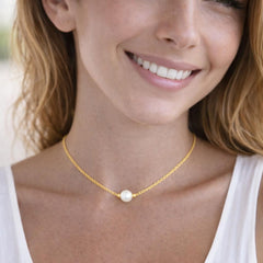 gold necklace with a pearl pendant