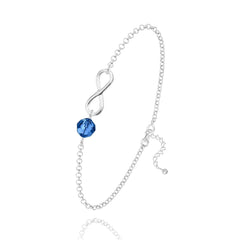 Sterling Silver infinity bracelet with Capri Blue crystal and rhodium plated finish