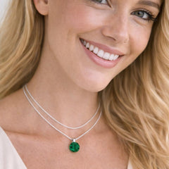 silver necklace with a green pendant