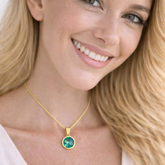 gold necklace with a green pendant