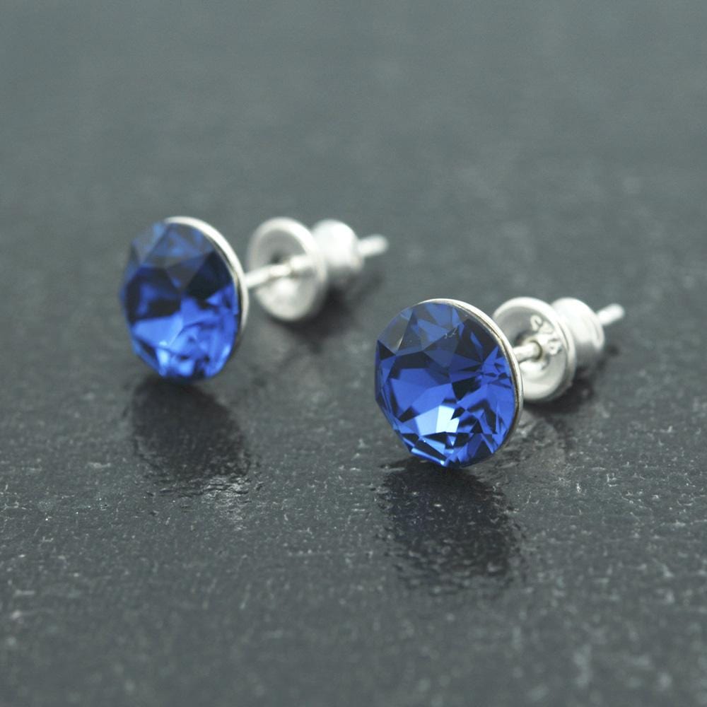 Sterling Silver sapphire blue crystal stud earrings with rhodium plated finish and round faceted crystal