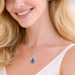 silver necklace with a blue pendant