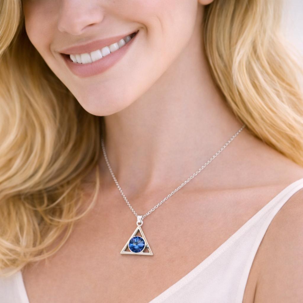 silver necklace with a blue gemstone pendant