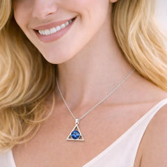 silver necklace with a blue gemstone pendant