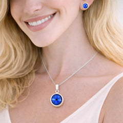 silver necklace with a blue pendant and matching earrings.