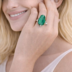 green gemstone ring with a silver band