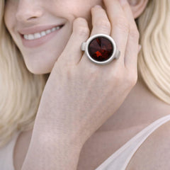 silver ring with a red gemstone