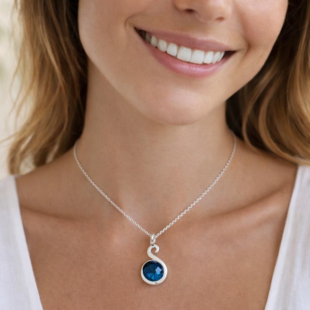 silver necklace with a blue pendant