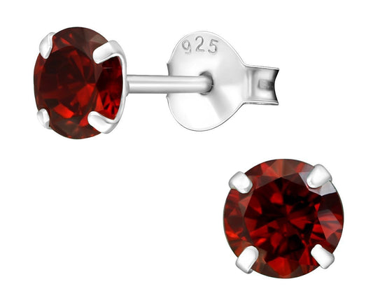 Sterling silver 5 mm garnet birthstone stud earrings with deep red round stones, four-prong settings and butterfly backs, available in Australia.