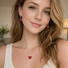 Woman wearing a necklace and heart-shaped earrings with a neutral background