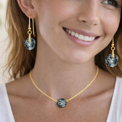 gold necklace and earrings with gemstones