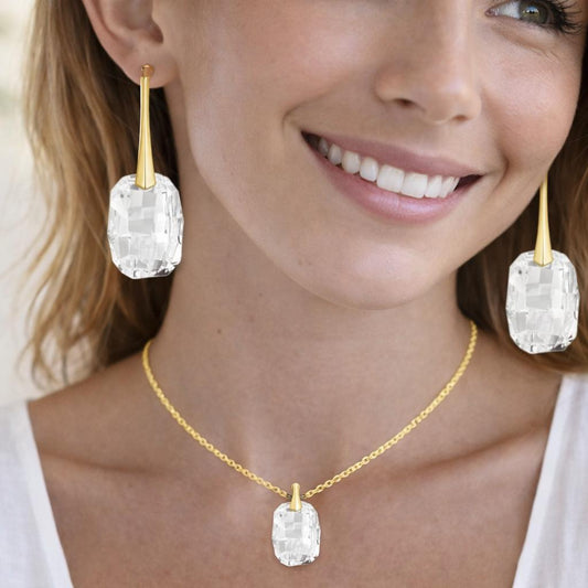 gold necklace and earrings with clear stones