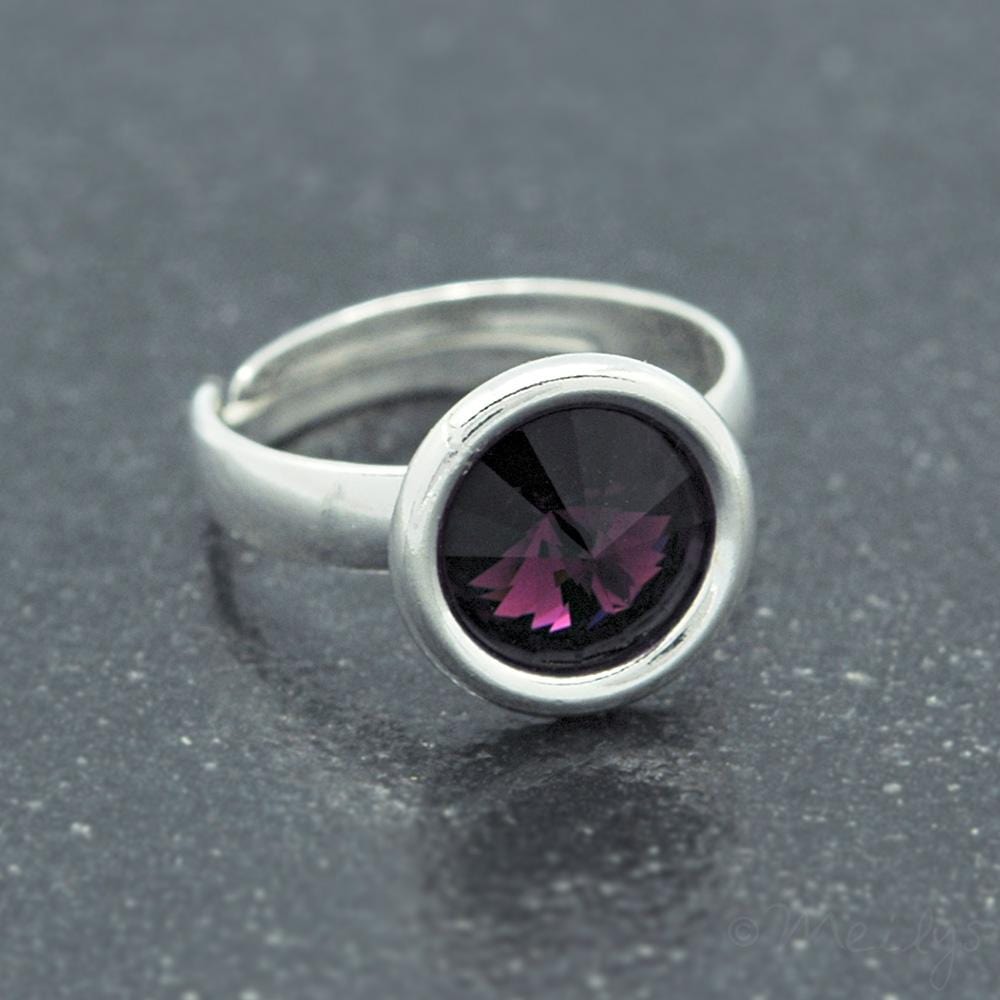 Adjustable sterling silver ring with a round faceted genuine amethyst in a polished circular setting