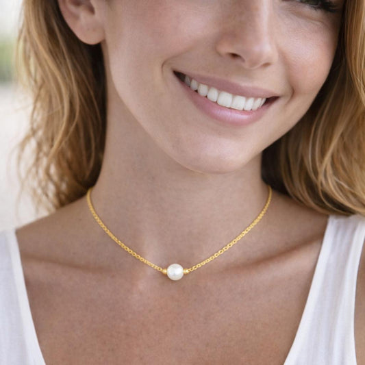 gold necklace with a pearl pendant