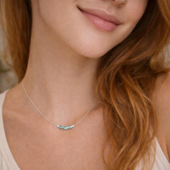 delicate necklace with blue beads.