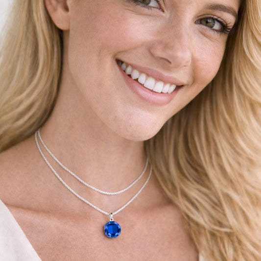 silver necklace with a blue pendant