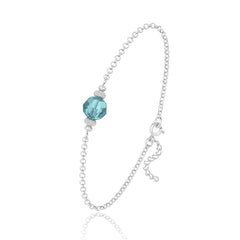 Sterling silver bracelet with an 8 mm faceted turquoise crystal, textured silver spacers and adjustable extension chain