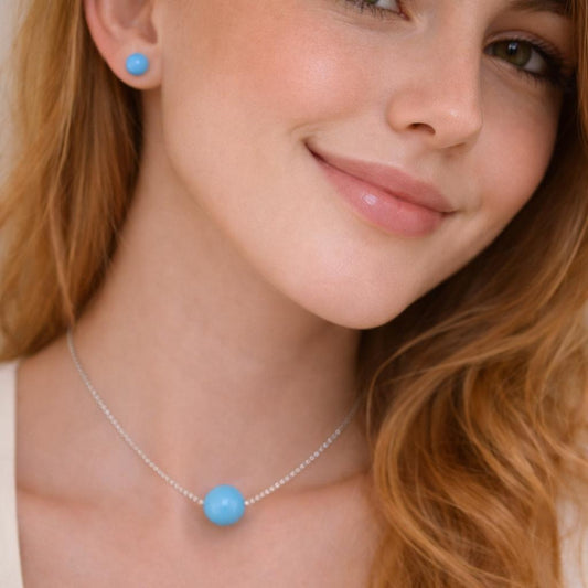 necklace with a blue pendant and matching earrings.