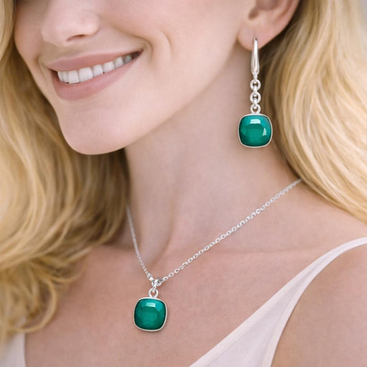 silver earrings and necklace with green gemstones