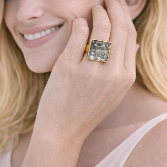 gold ring with a square gemstone 