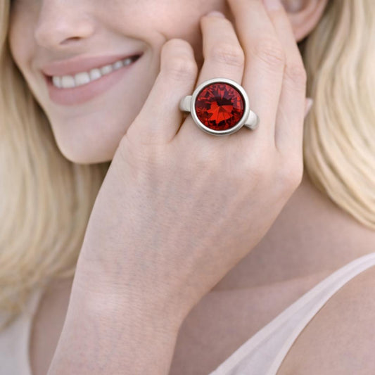 silver ring with a red gemstone