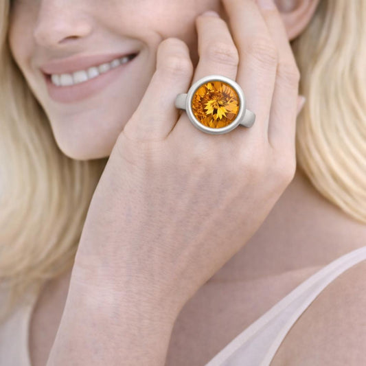 silver ring with a large orange gemstone.