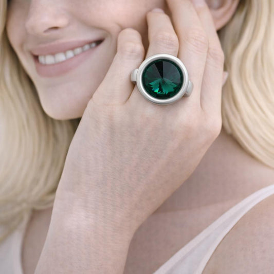silver ring with a green gemstone
